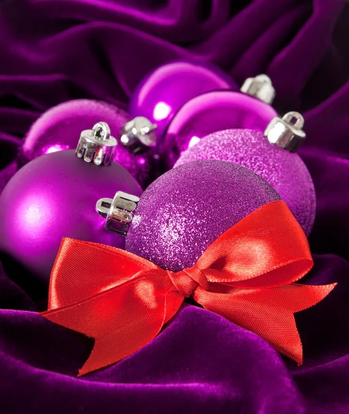 Violet Christmas balls on a violet background — Stock Photo, Image