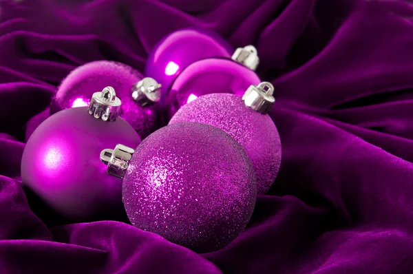 Violet Christmas balls on a violet background — Stock Photo, Image