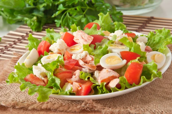 Fresh salmon salad, lettuce and quail eggs — Stock Photo, Image
