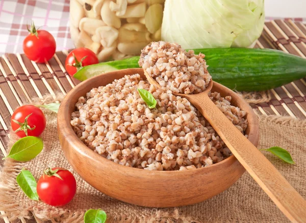 Buckwheat porridge in a wooden bowl — Stock Photo, Image