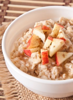 elma ve tarçın beyaz bir kase yulaf ezmesi