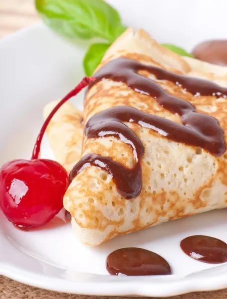 Pancakes with chocolate and cherries — Stock Photo, Image