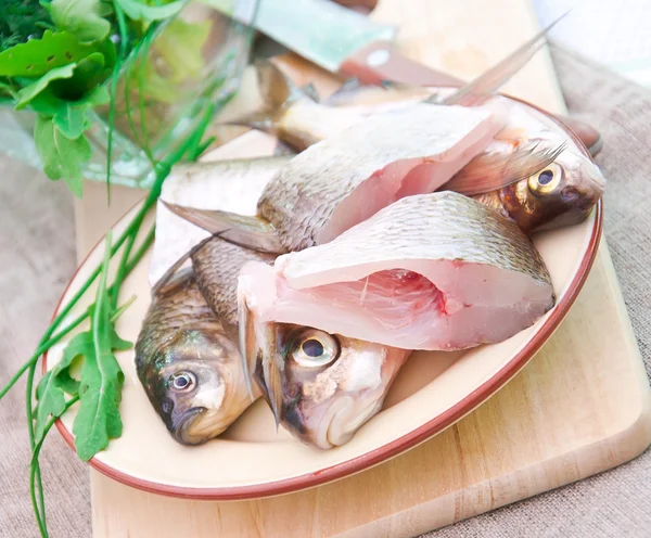 Raw fish on a plate — Stock Photo, Image