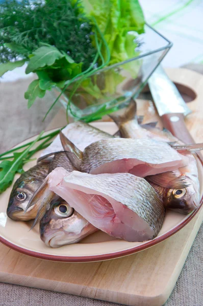 Raw fish on a plate — Stock Photo, Image