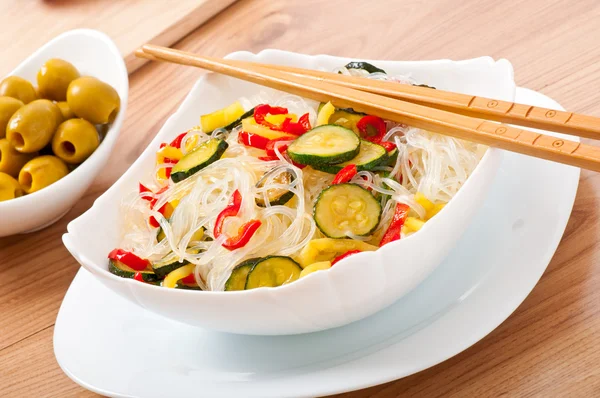 Рисовая лапша и овощи на белой тарелке — стоковое фото