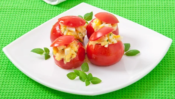 Tomatoes stuffed with cheese, egg with fresh herbs basil — Stock Photo, Image