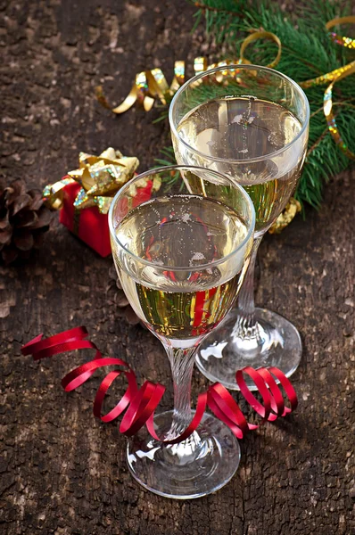 Two glasses of champagne on a dark old wooden background — Stock Photo, Image