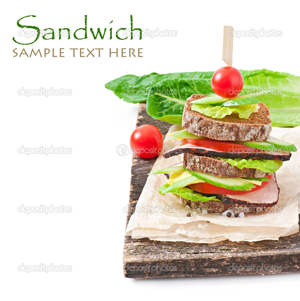 Sandwich with ham and fresh vegetables on white background