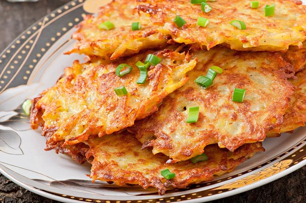 Fried potato pancakes on the old wooden background — Stock Photo, Image