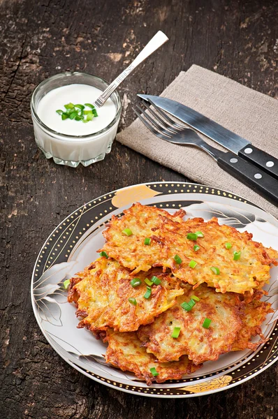 Fried potato pancakes on the old wooden background — Stock Photo, Image