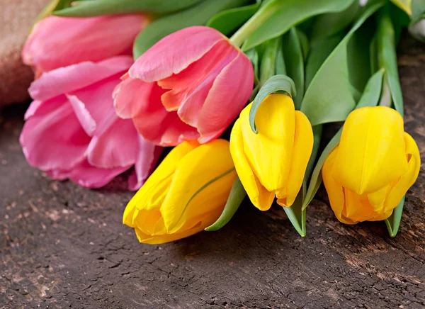 Bouquet of tulips on old wooden background — Stock Photo, Image