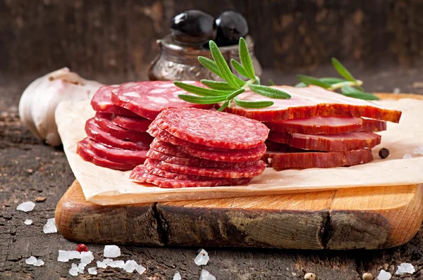 Assorted deli meats, rosemary and pepper — Stock Photo, Image