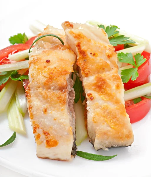 Fried filet fish and fresh vegetable salad Royalty Free Stock Images