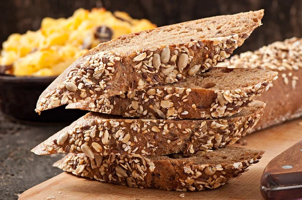 Slices of finest organic bread decorated with natural cereals — Stock Photo, Image