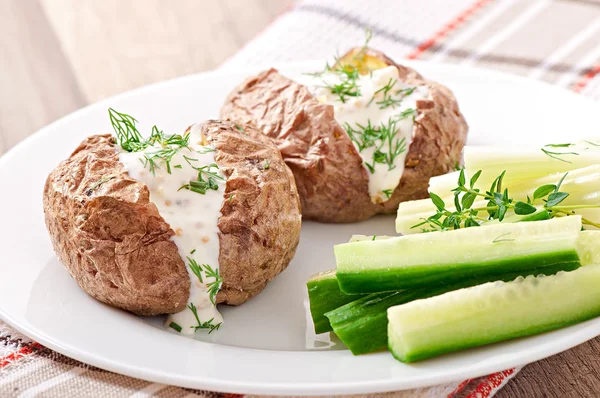 Baked potato filled with sour cream — Stock Photo, Image