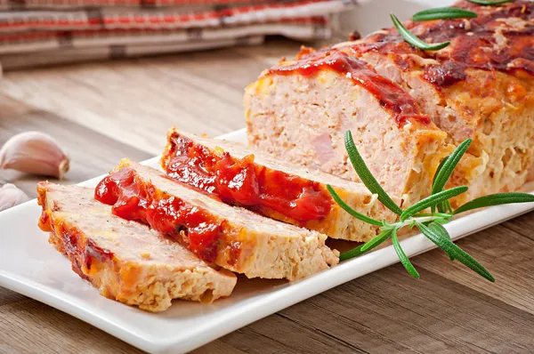 Homemade ground meatloaf with ketchup and rosemary — Stock Photo, Image