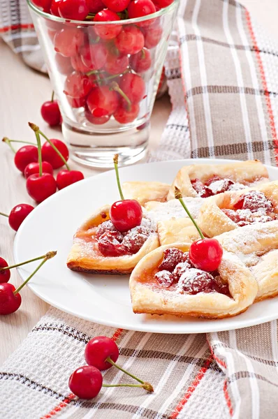 Tasty puff with a sweet cherry — Stock Photo, Image