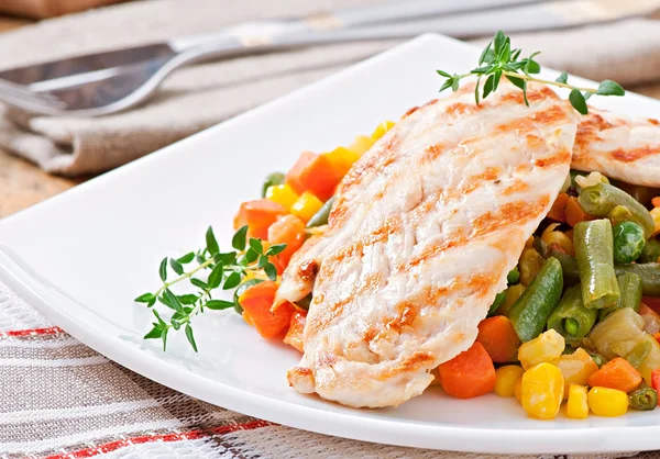 Grilled chicken breasts and vegetables Stock Image