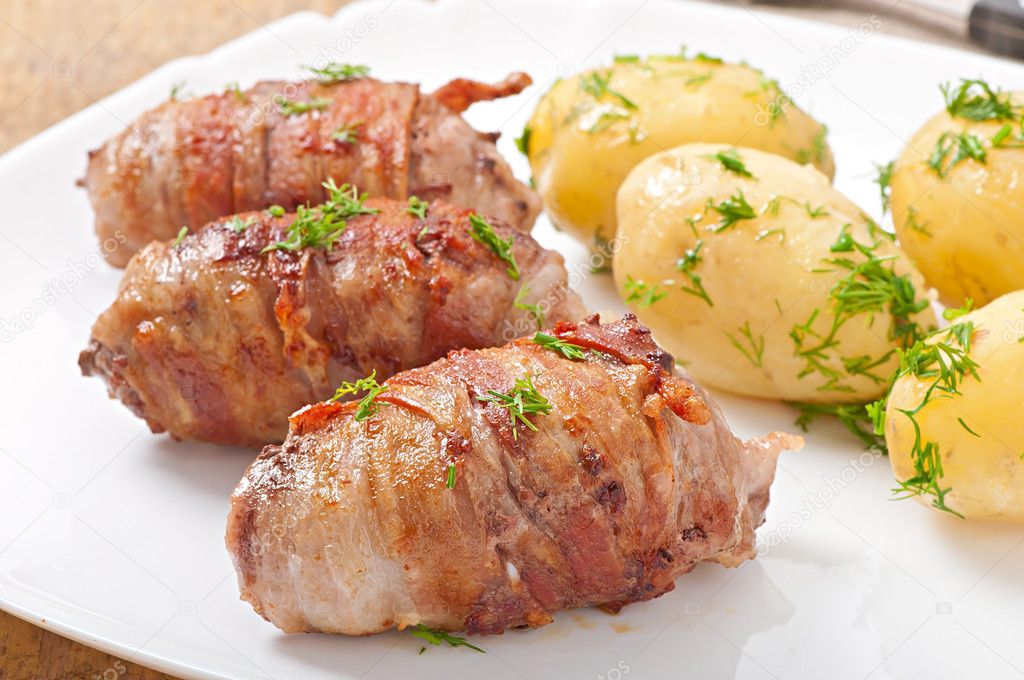 Grilled meat rolls wrapped in strips of bacon
