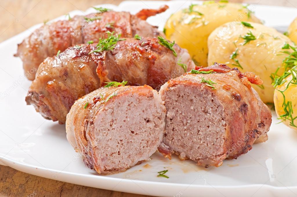 Grilled meat rolls wrapped in strips of bacon