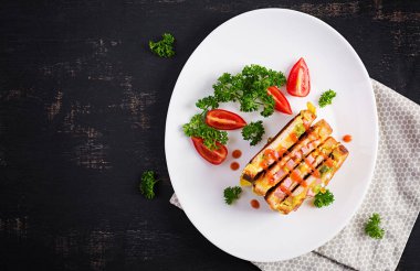 Kızarmış sandviç peyniri, biber ve çırpılmış yumurta. Karanlık arka plan. Üst manzara, düz uzanma