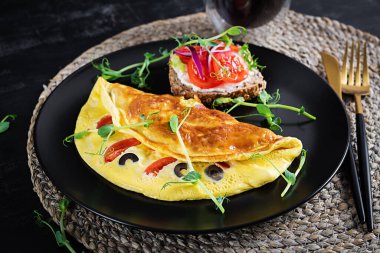 Sağlıklı kahvaltı. Domatesli, peynirli ve zeytinli omlet. Krem peynirli ve domatesli sandviç..