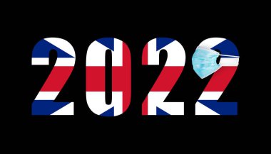 Britanya bayrağı 2022 sayısının arka planına karşı covid maskeli