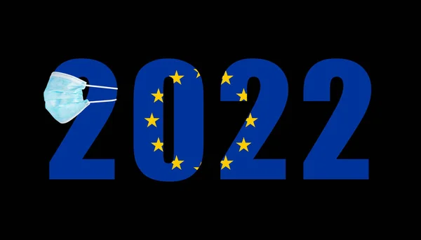 Covidのマスク中の2022の数を背景に欧州連合の旗 — ストック写真