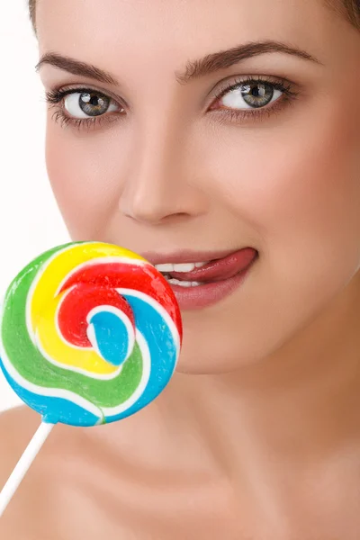 Young girl with a lollipop near her lips — Stock Photo, Image