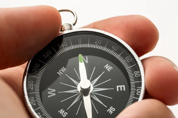 Hand holding silver black compass — Stock Photo, Image