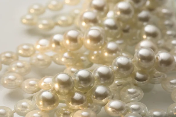 Shining string of white pearl in water — Stock Photo, Image