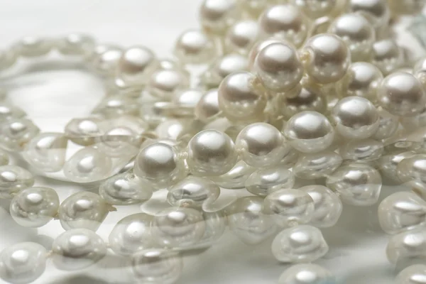 Shining string of white pearl in water — Stock Photo, Image