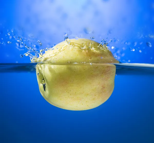 Yellow apple in water splash — Stock Photo, Image