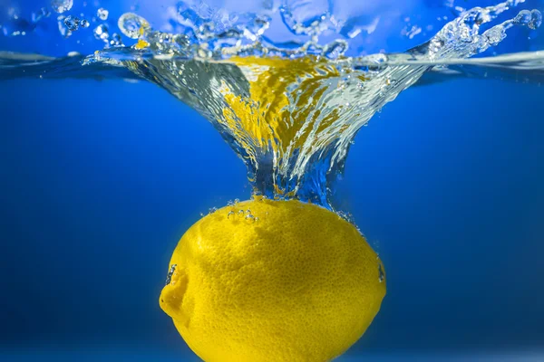 Yellow lemon in water splash — Stock Photo, Image