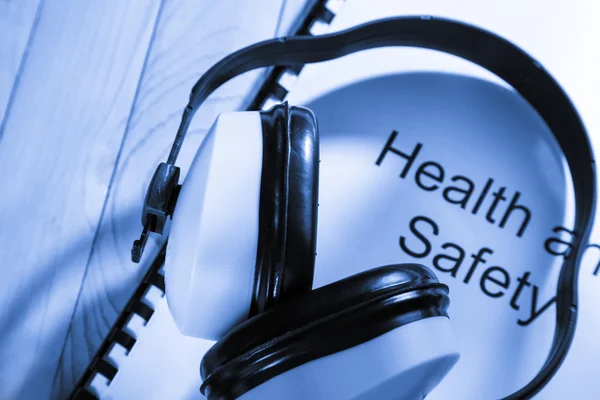 Health and safety register with earphones — Stock Photo, Image