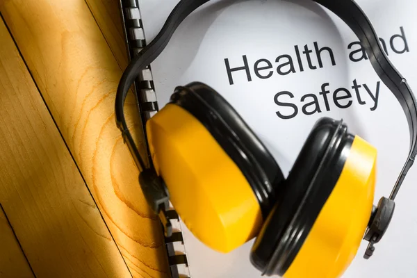 Health and safety register with earphones — Stock Photo, Image