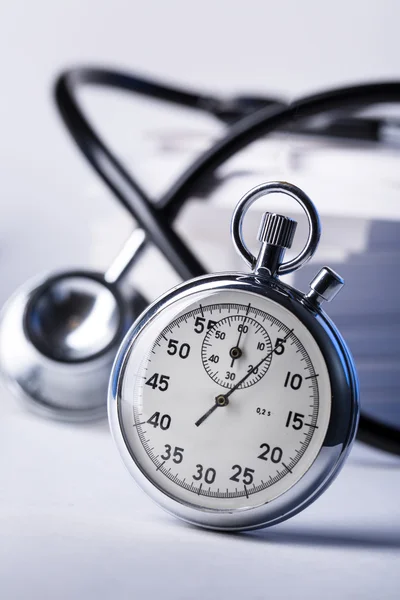Pile of paper cards, stethoscope and stopwatch — Stock Photo, Image