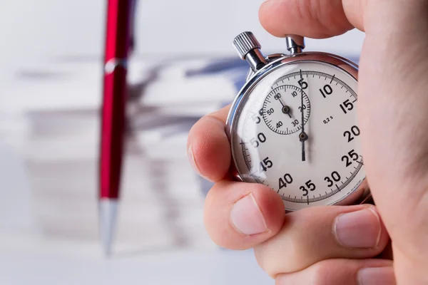 Stopwatch and pen on background of paper cards — Stock Photo, Image