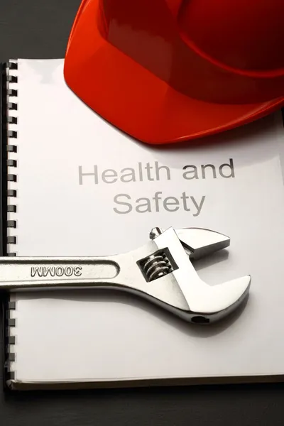 Register with helmet and spanner — Stock Photo, Image