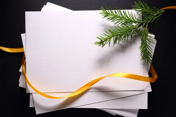 Stack of paper cards and twig of evergreen fir — Stock Photo, Image