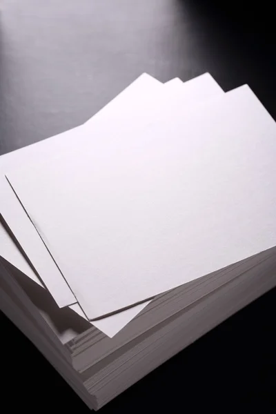 Stack of white paper cards on black — Stock Photo, Image