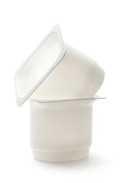 Empty plastic yoghurt pots on white — Stock Photo, Image