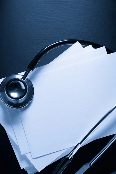 Stethoscope and heap of paper cards — Stock Photo, Image