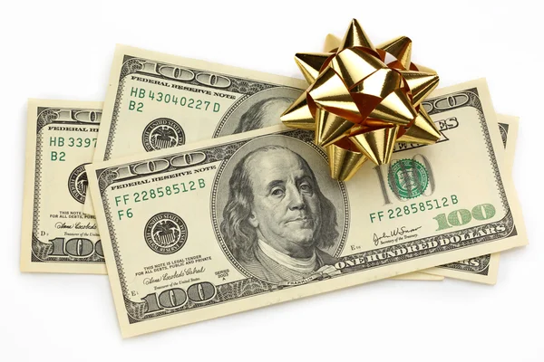 Dollars with decorative bow on white — Stock Photo, Image