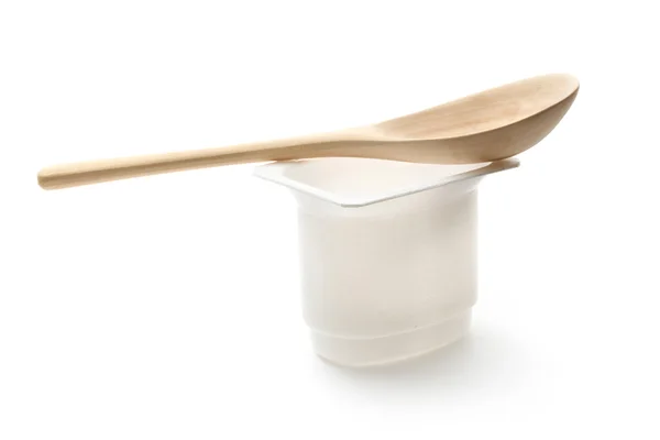 Empty plastic yoghurt pot with spoon — Stock Photo, Image