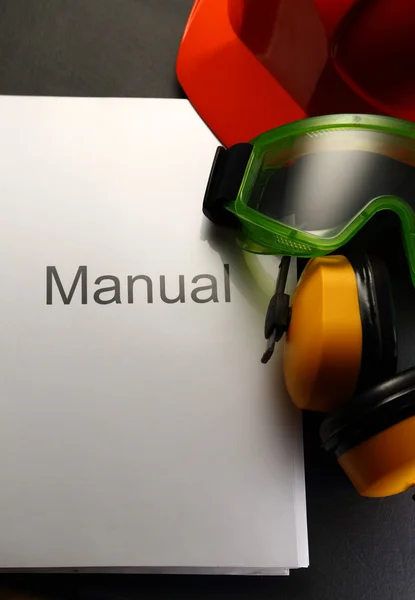 Manual with helmet, goggles and headphones — Stock Photo, Image
