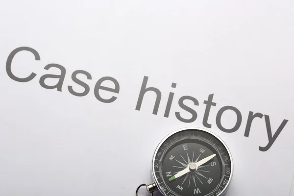 Case history and compass — Stock Photo, Image