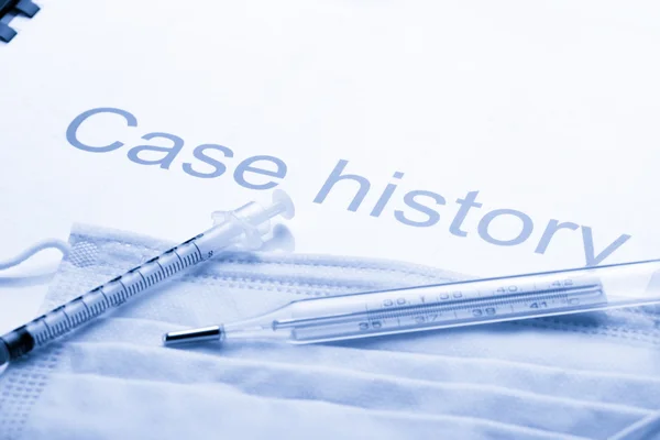 Case history, mask, syringe and thermometer — Stock Photo, Image