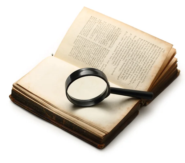 Lupe und altes Buch auf weißem Hintergrund — Stockfoto