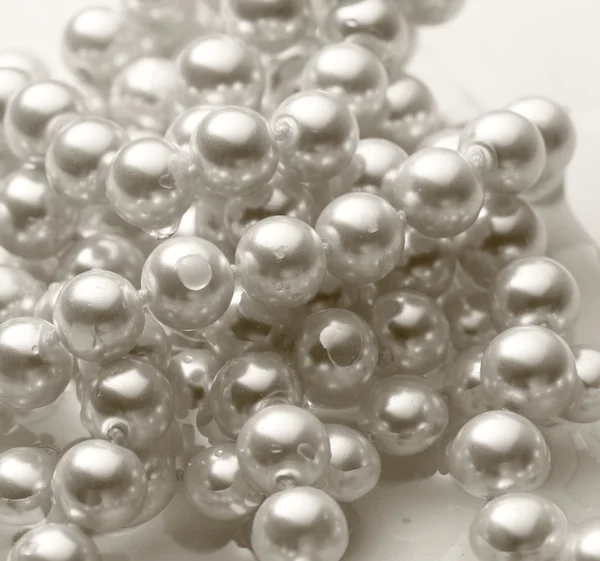 Shining string of white pearl in water — Stock Photo, Image